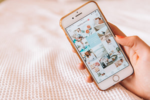 woman holding cell phone with instagram open